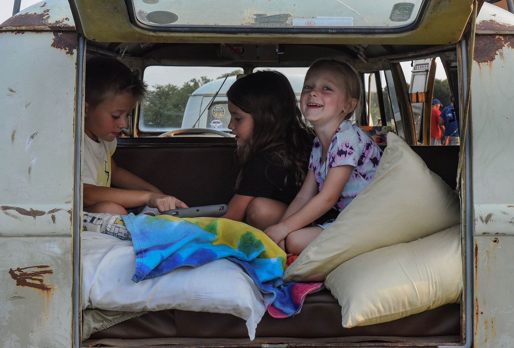 From left, Maxwell Marple, Betsy Pitchford and Lucille Stubblefield sit in the back of a Volkswagen